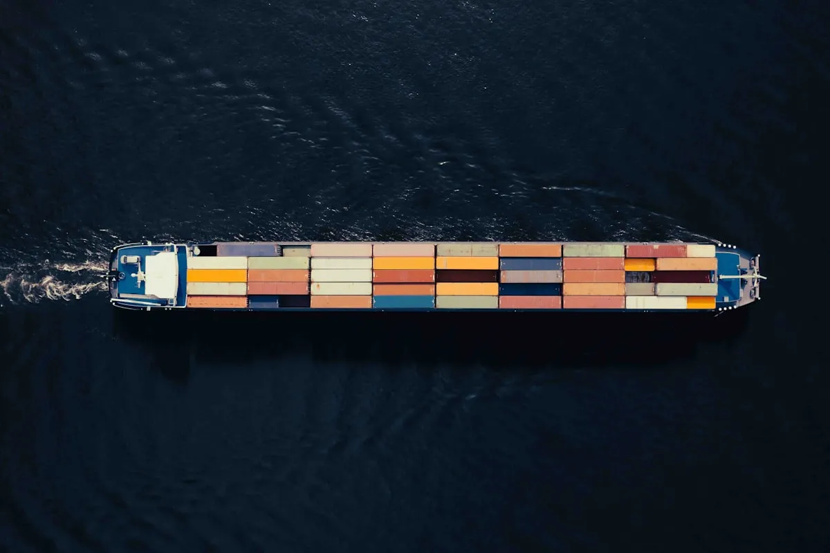 a large container ship in a body of water. Photo by Bernd Dittrich on Unsplash