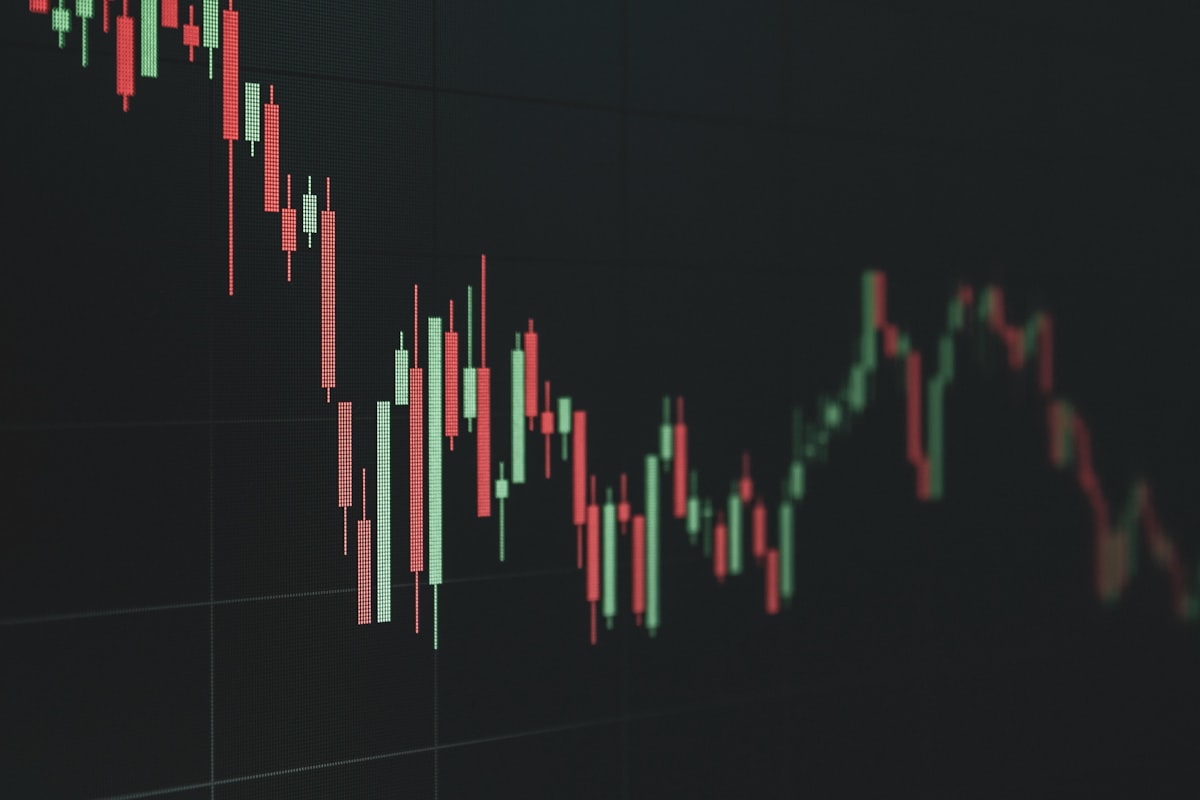 Candlestick stock chart showing a falling trend on a dark screen