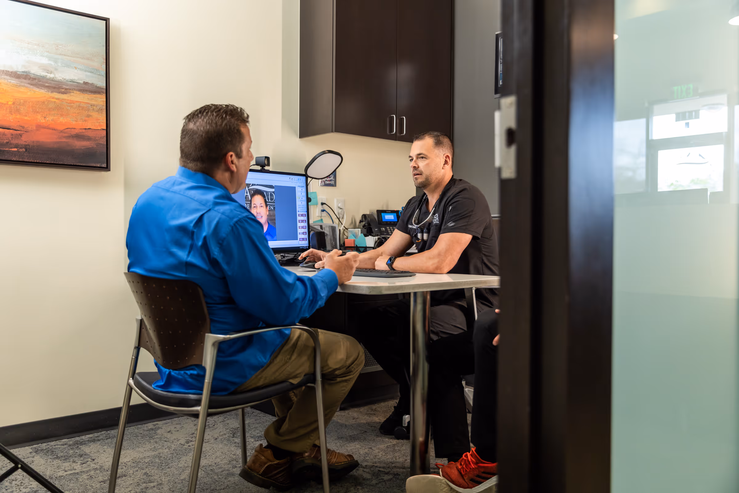 Dr. Bennett discussing dental implant options with patient at Arvada Dental Center & Implants