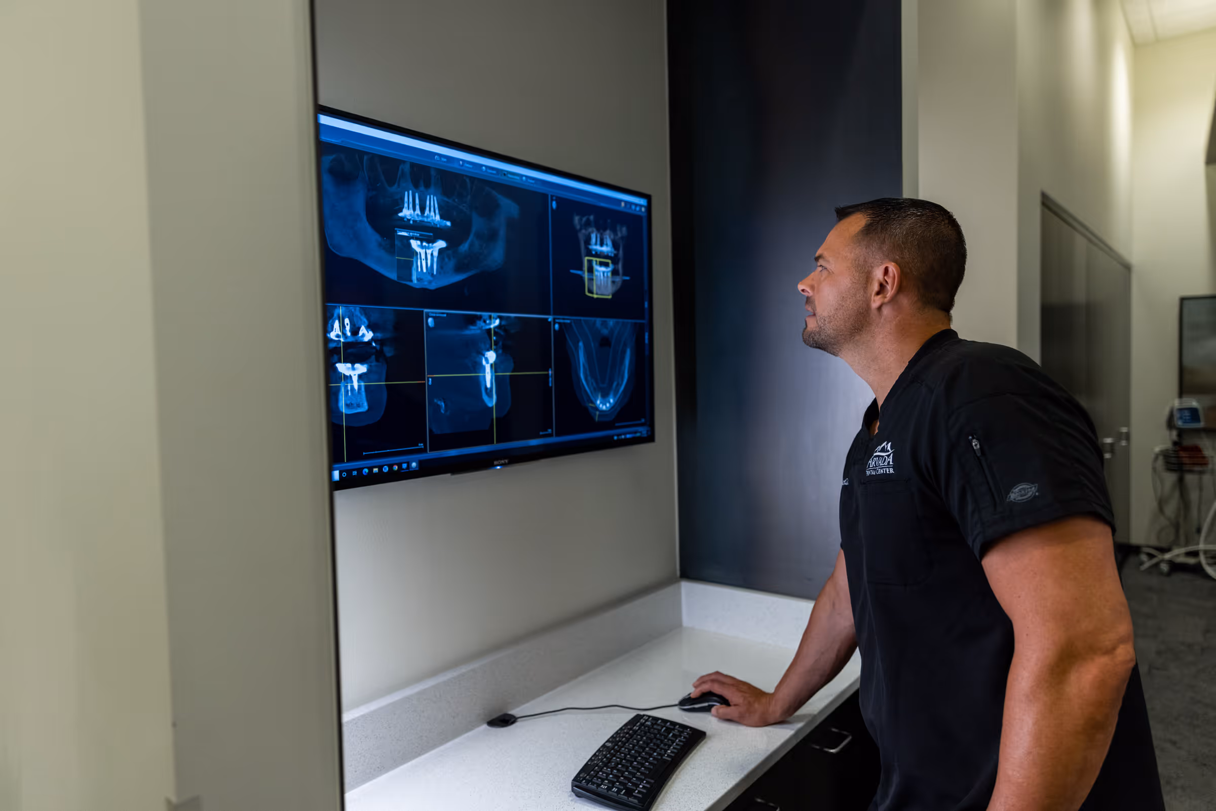 Dr. Bennett using 3D CBCT imaging for dental implant planning at Arvada Dental Center & Implants