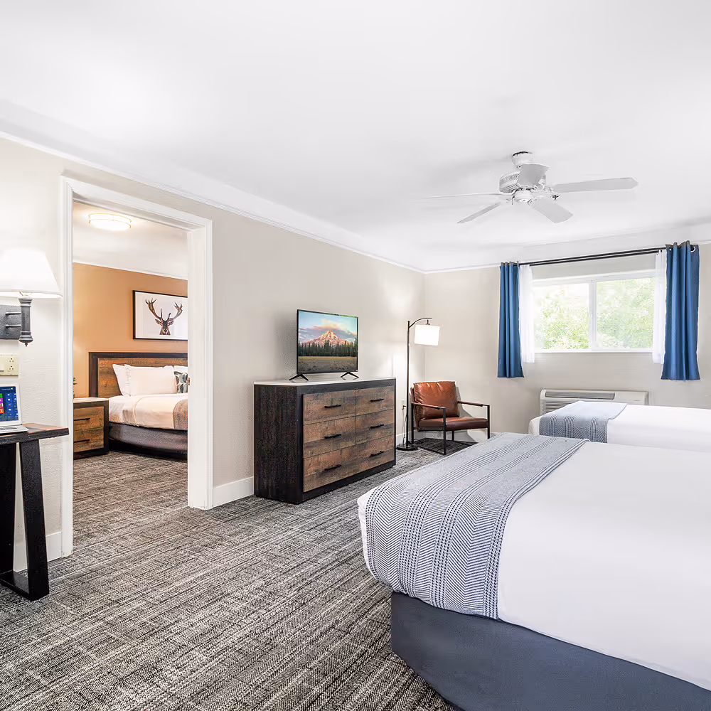 The Family Suite layout — two queen beds in one room, a king bedroom just through the doorway.