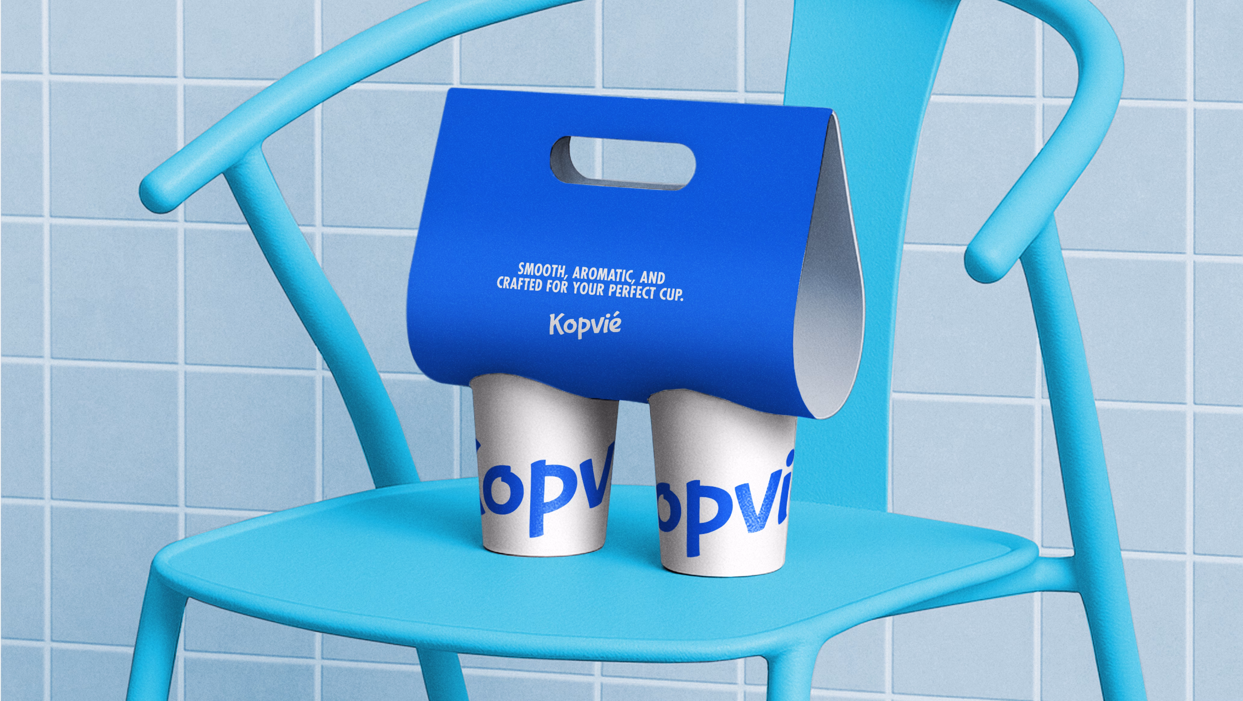 Kopvié paper cup design featuring bold blue branding and coffee house identity