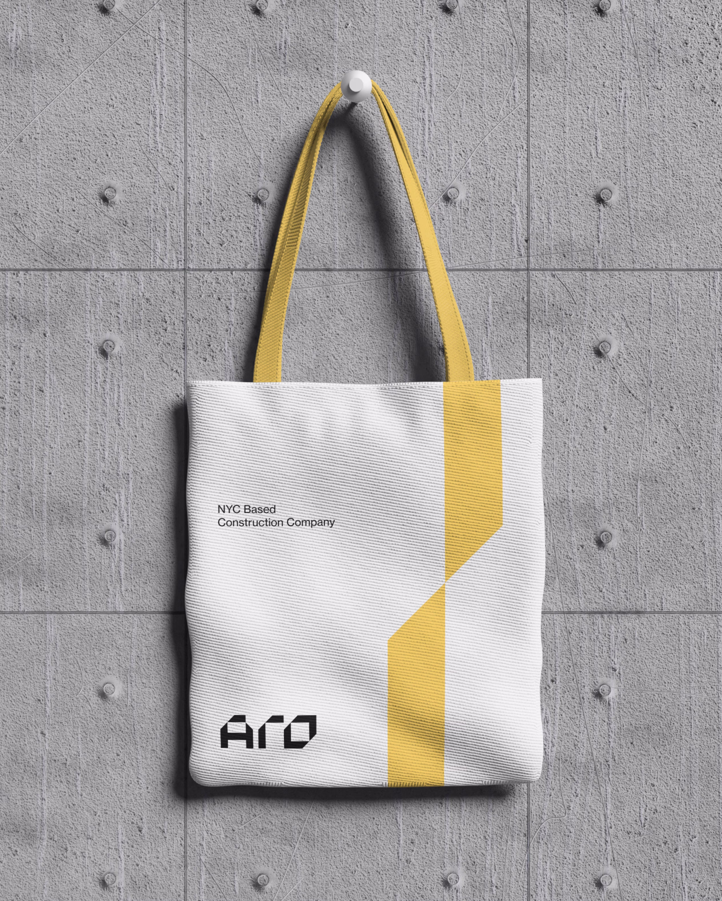ARO Construction promotional tote bag design featuring yellow and black branding
