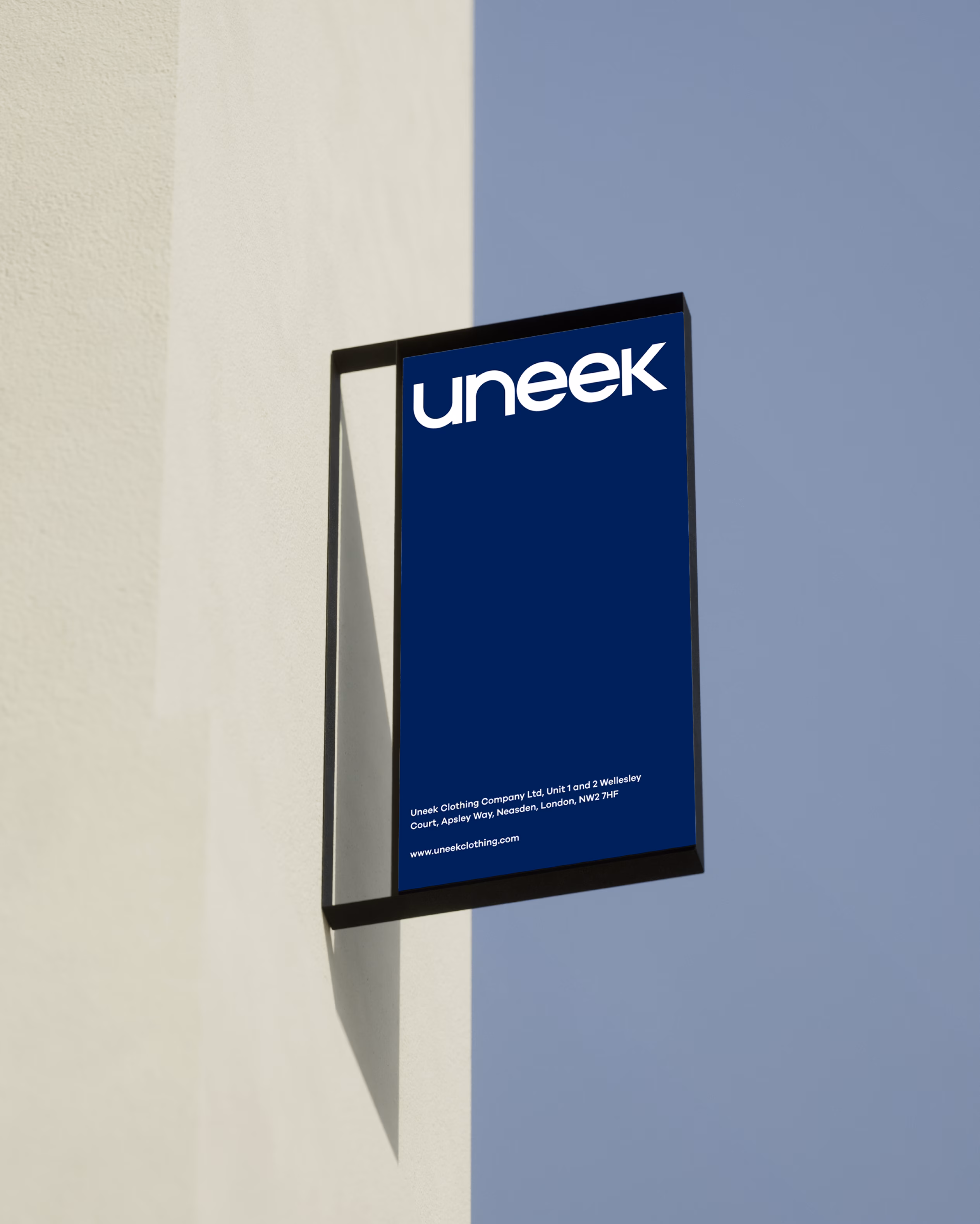 Uneek Clothing environmental branding and storefront signage design by Hatypo