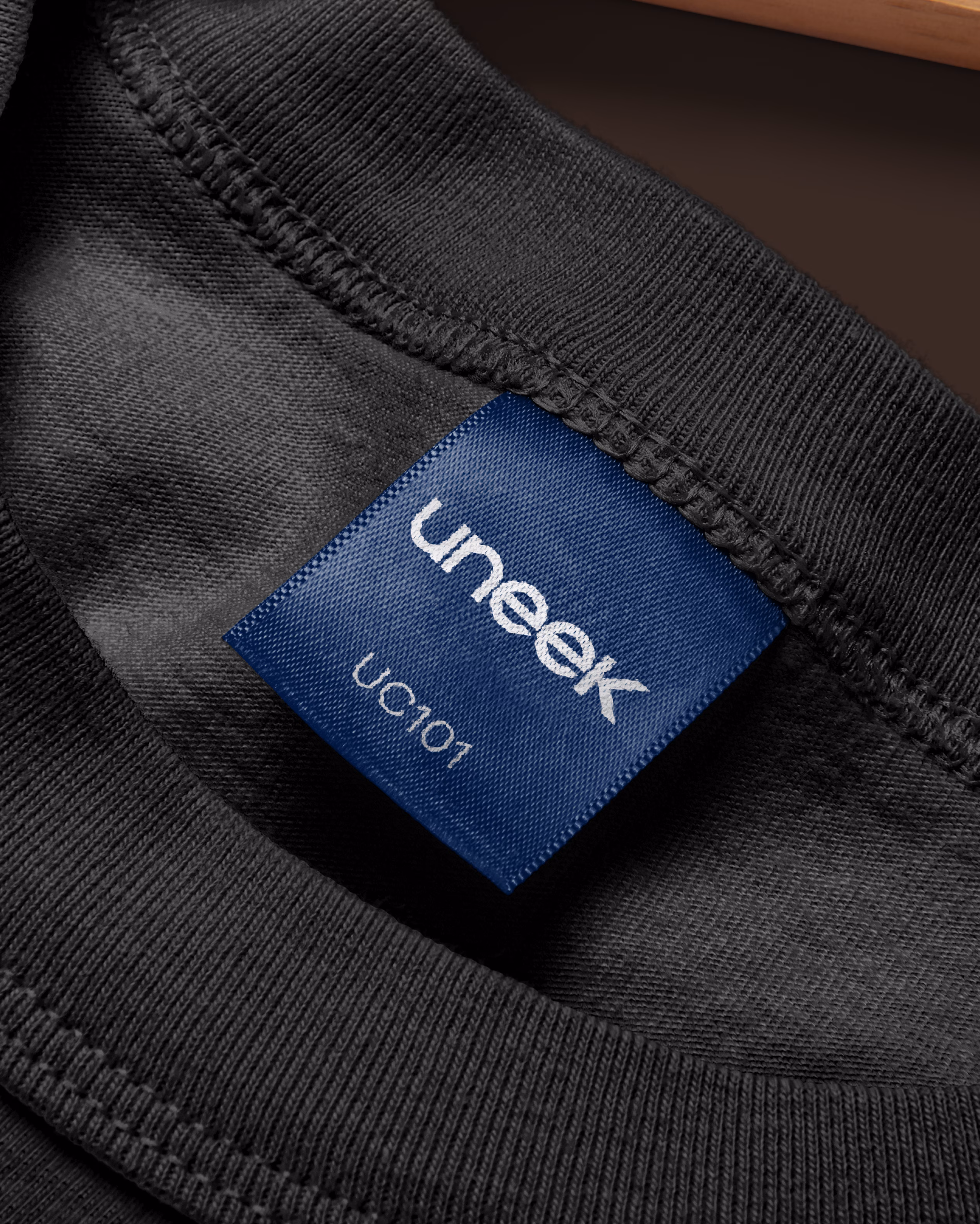 Uneek Clothing product labels and hang tags showing brand identity system
