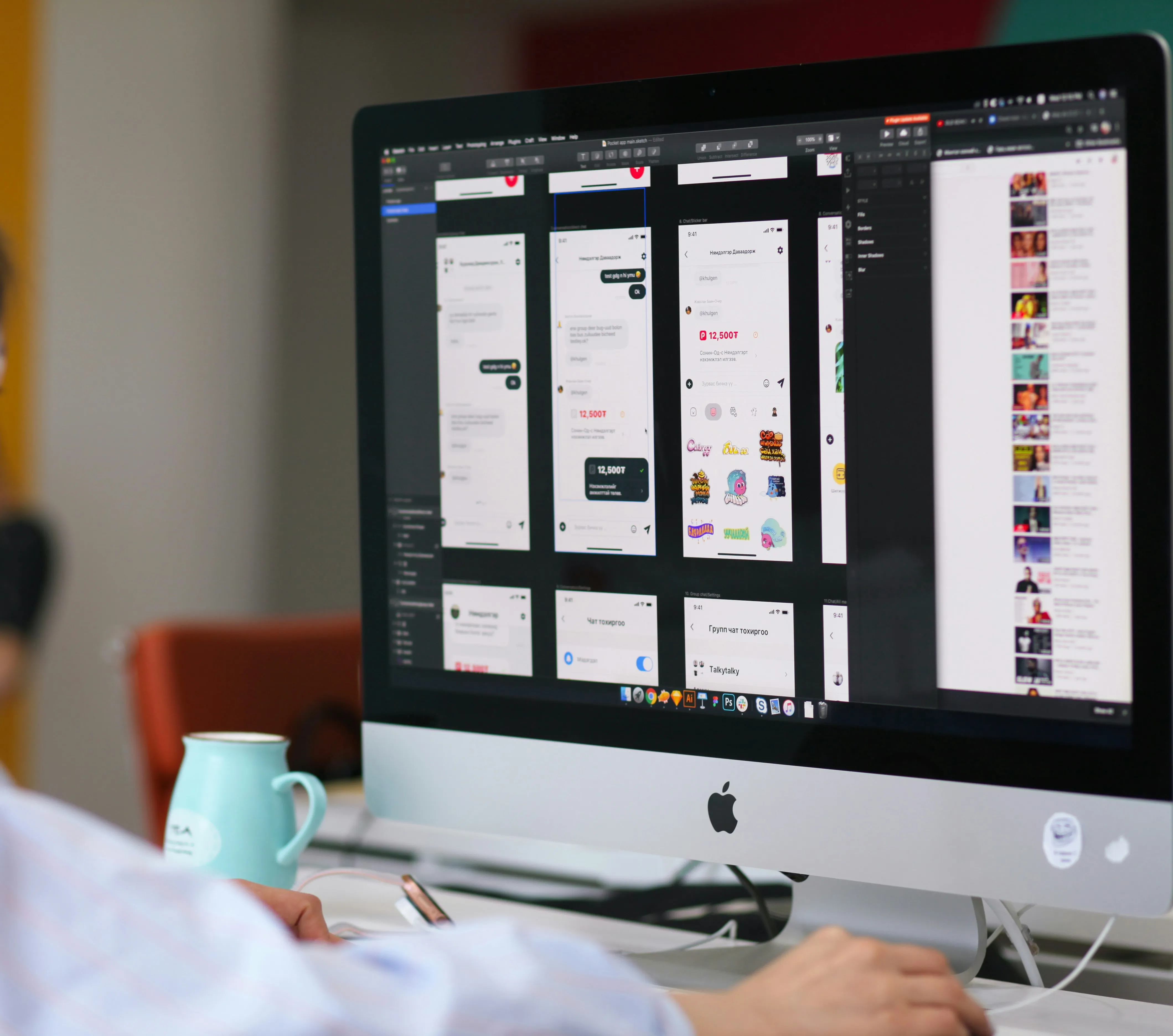 A man sitting in front of a computer monitor.