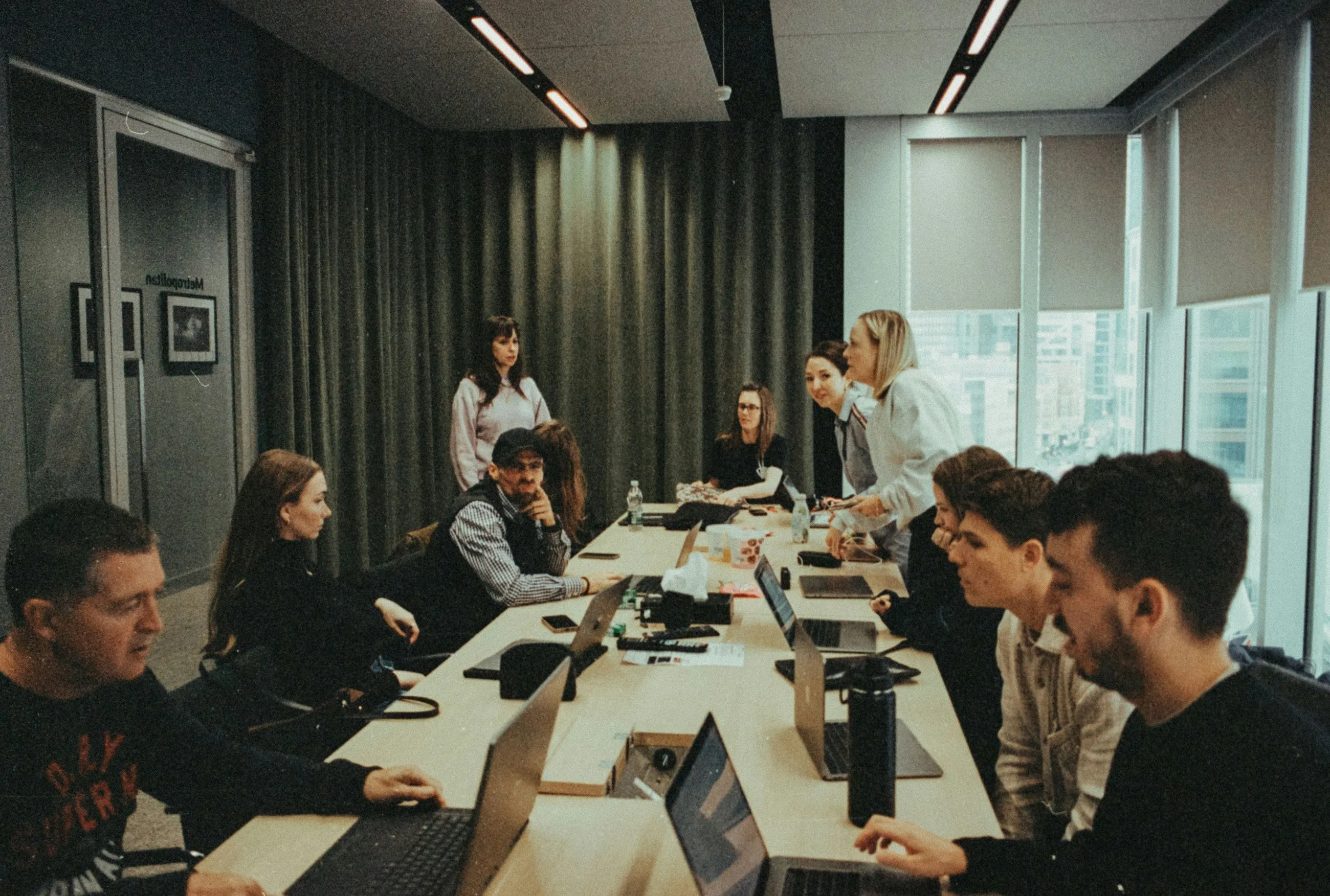 A group of people sitting around a long table.