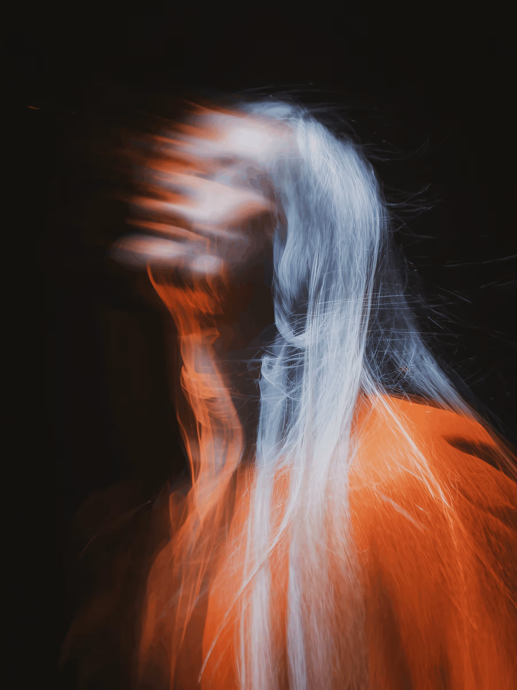 Abstract portrait of a person with white hair and red clothing blurred with motion effect.