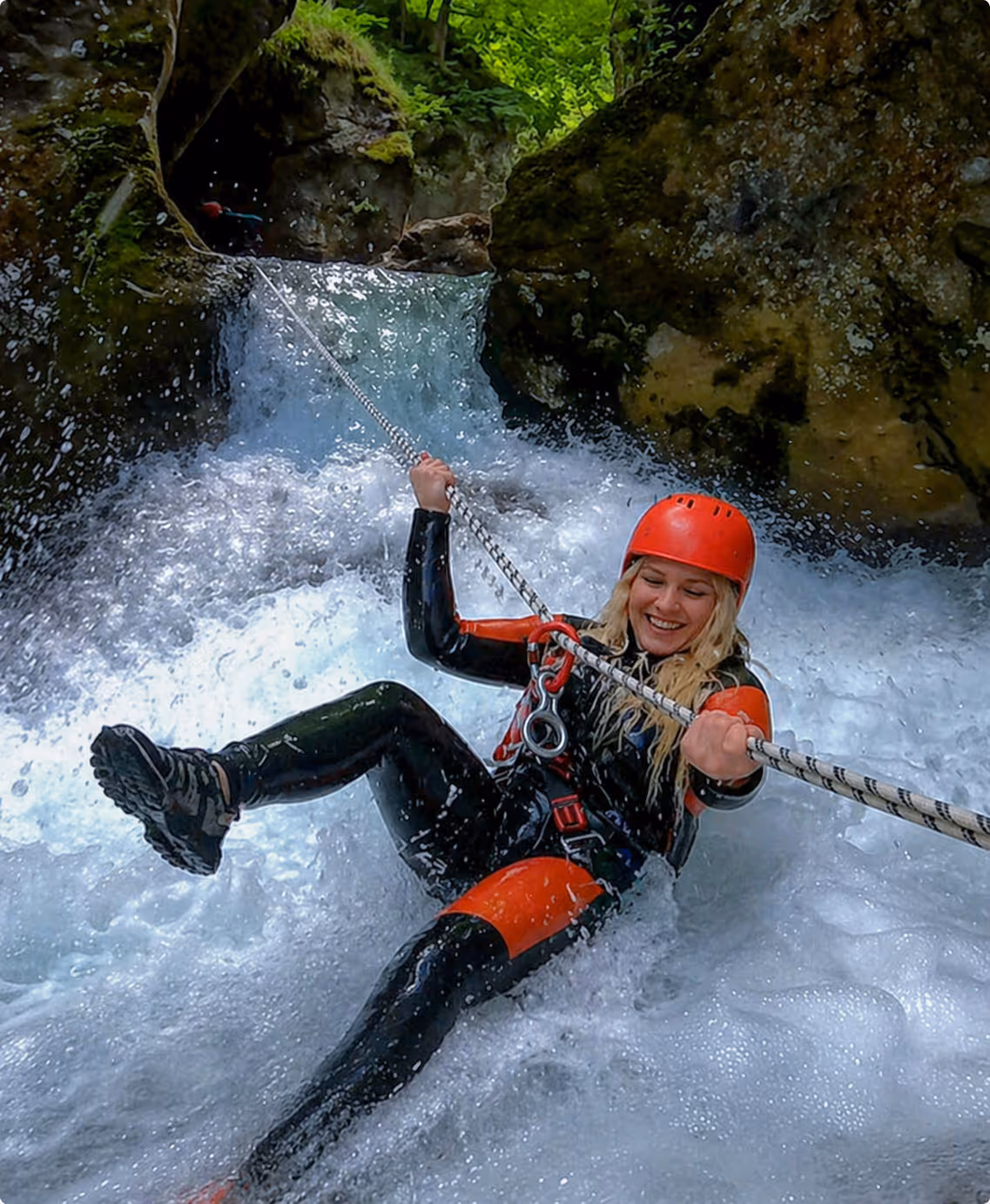 Girl rappelling down waterfall canyoning Hrcavka Bosnia