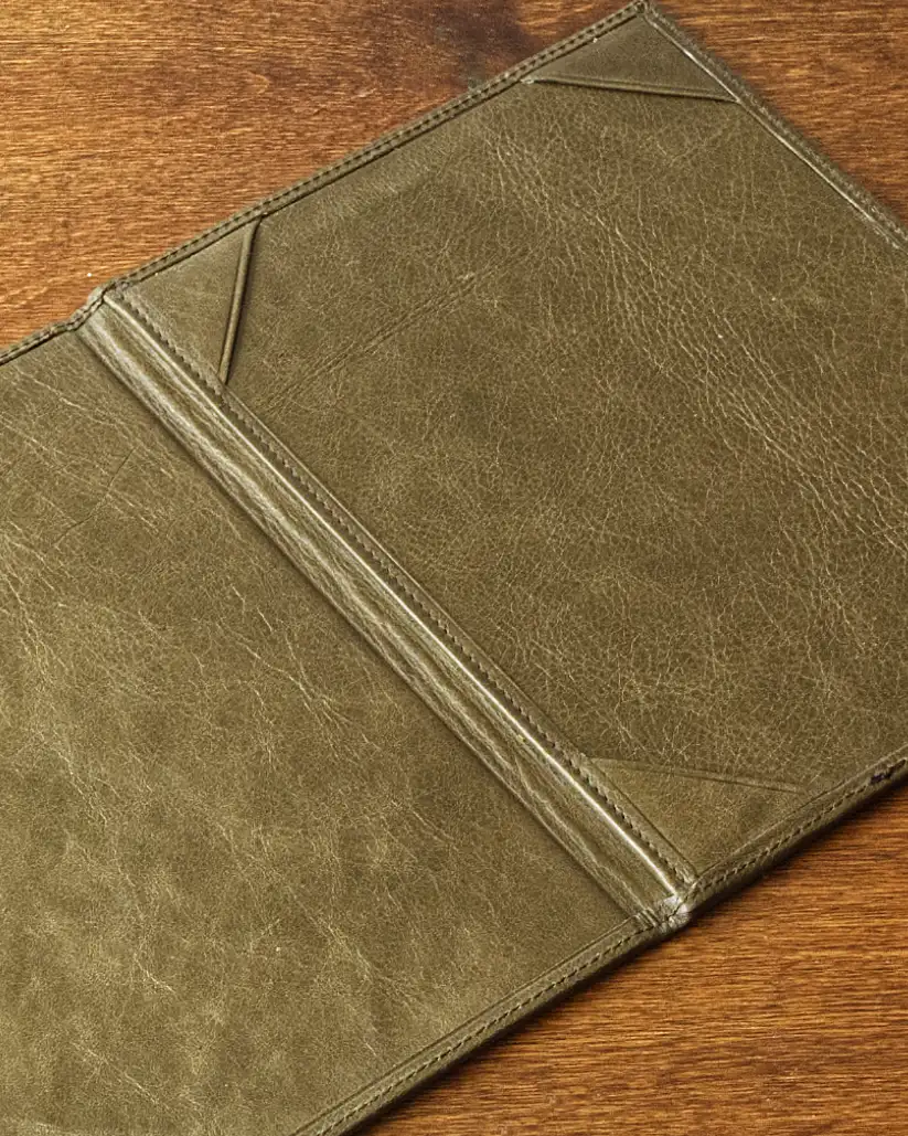 Detail of the interior of a leather menu showing the corners inside to hold the printed paper