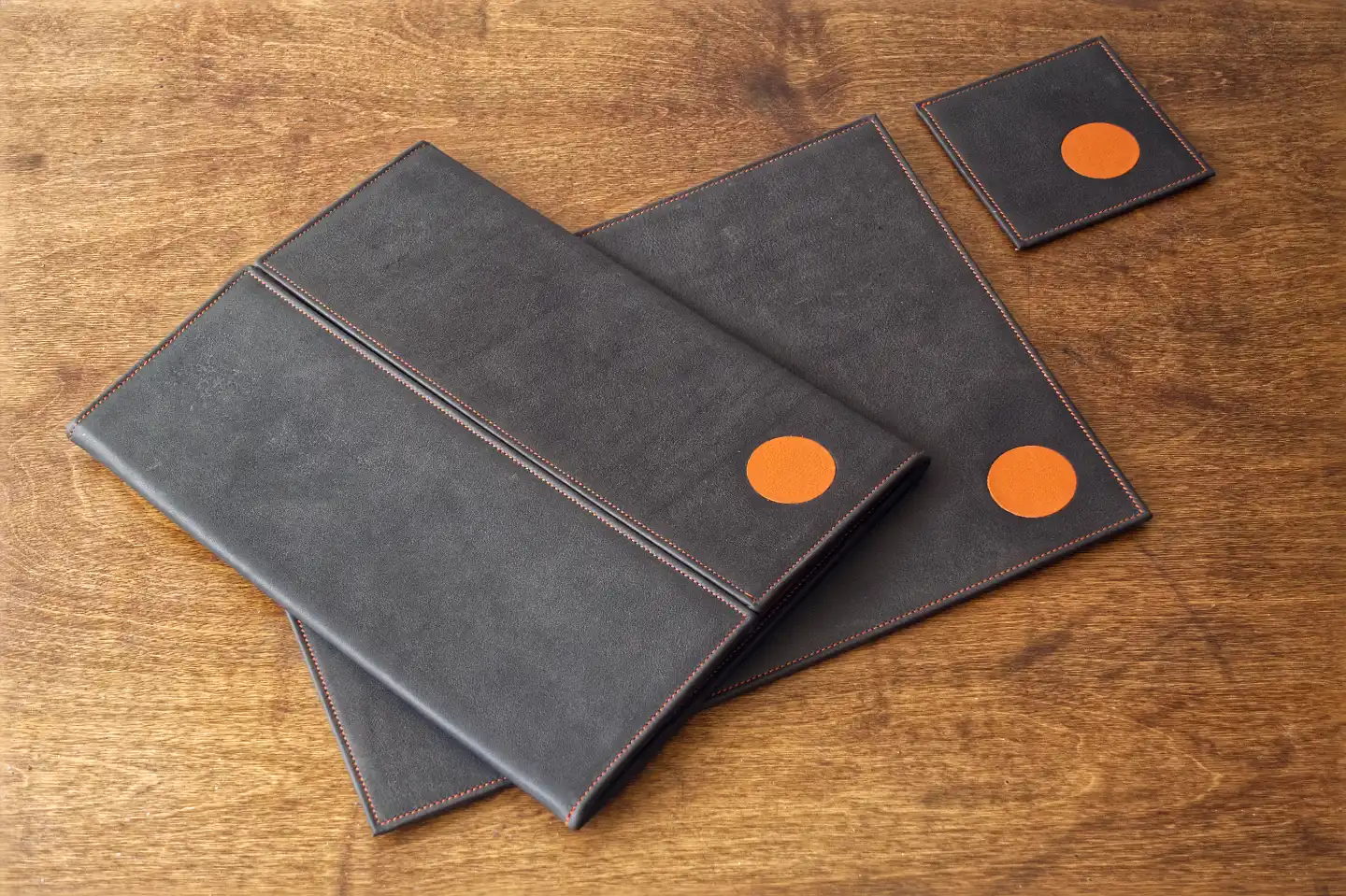 A bespoke tri fold leather menu, place mat and coaster with leather marquetry inlay