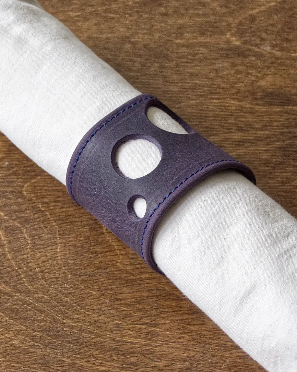 Nubuck napkin ring with decorative holes punched through it