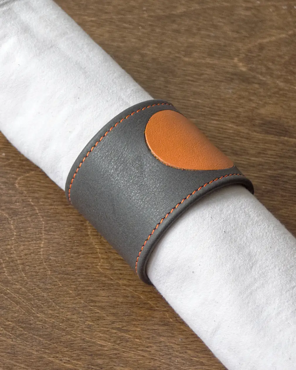 Grey calf leather napkin ring with orange spot inlay