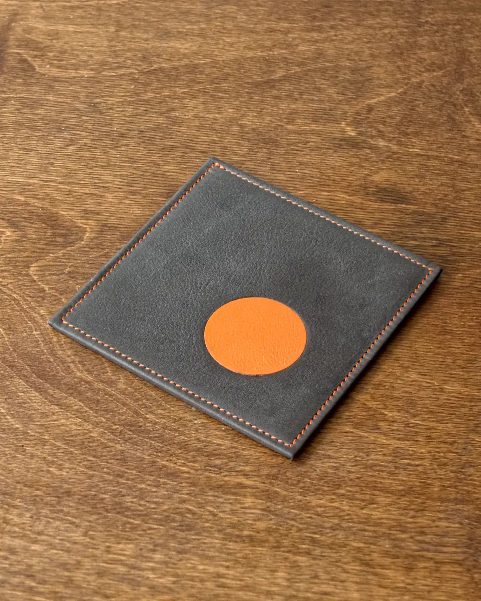 Calf leather drinks coaster with orange spot inlay