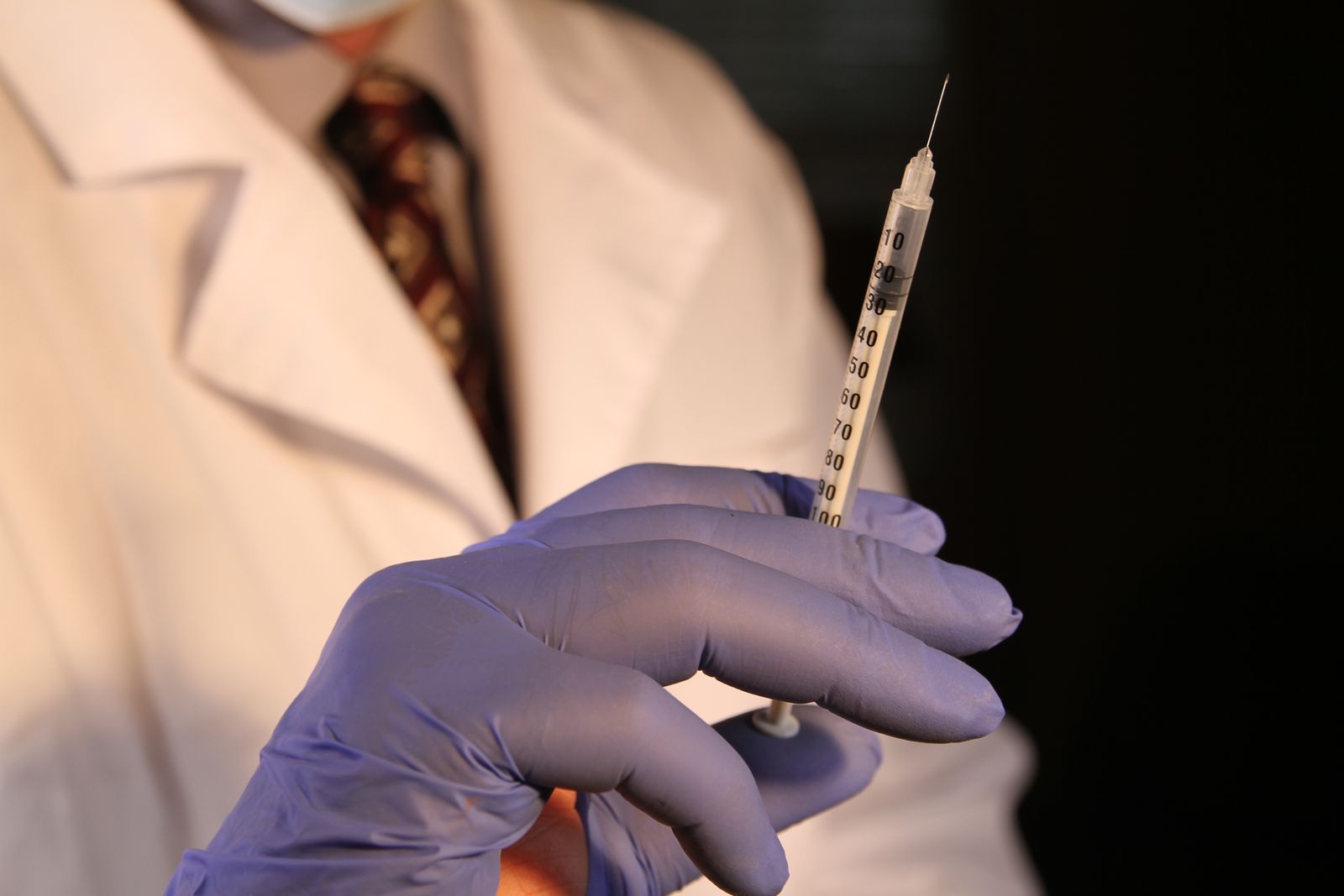 Clinician preparing an underarm hyperhidrosis treatment in a calm London clinic treatment room