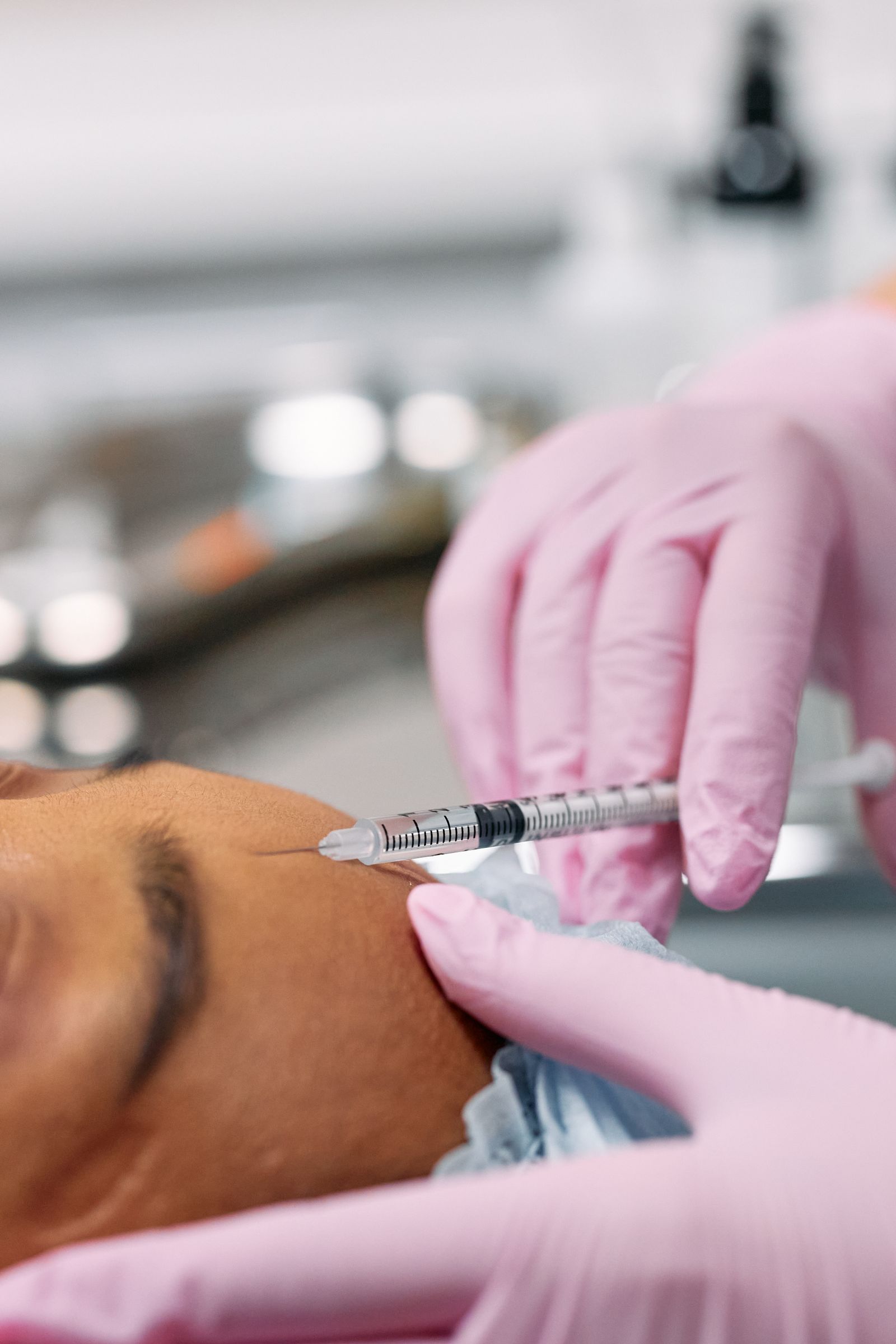 Practitioner marking injection points on a patient's forehead before anti-wrinkle treatment at a London clinic