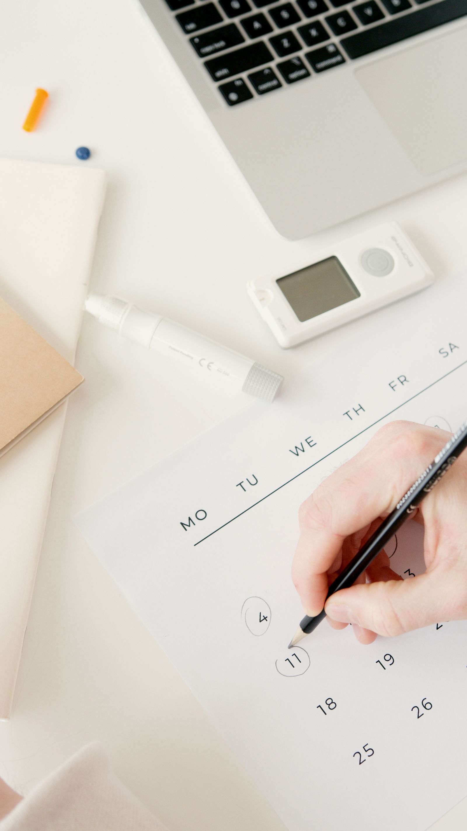 Woman with hydrated, radiant skin marking an event date on a calendar while planning a skin booster course