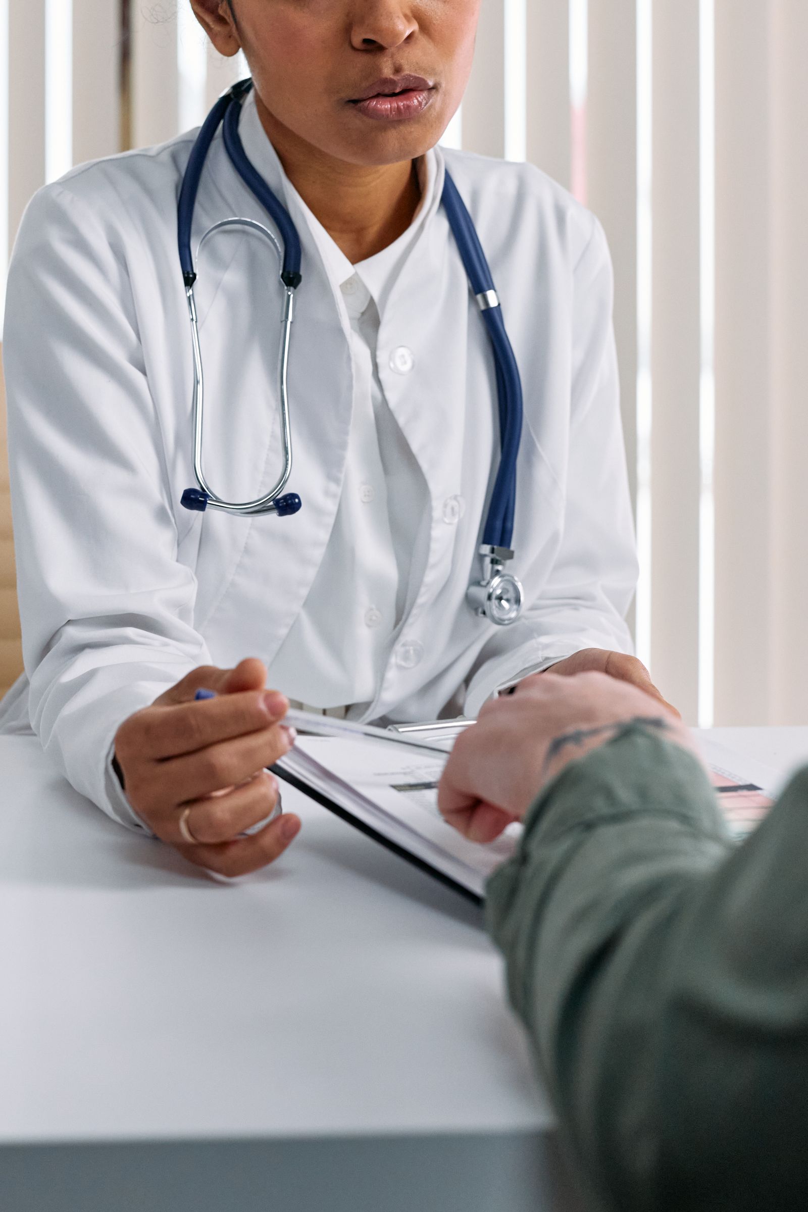Clinician reviewing a patient's treatment records during a face-to-face weight management consultation in London