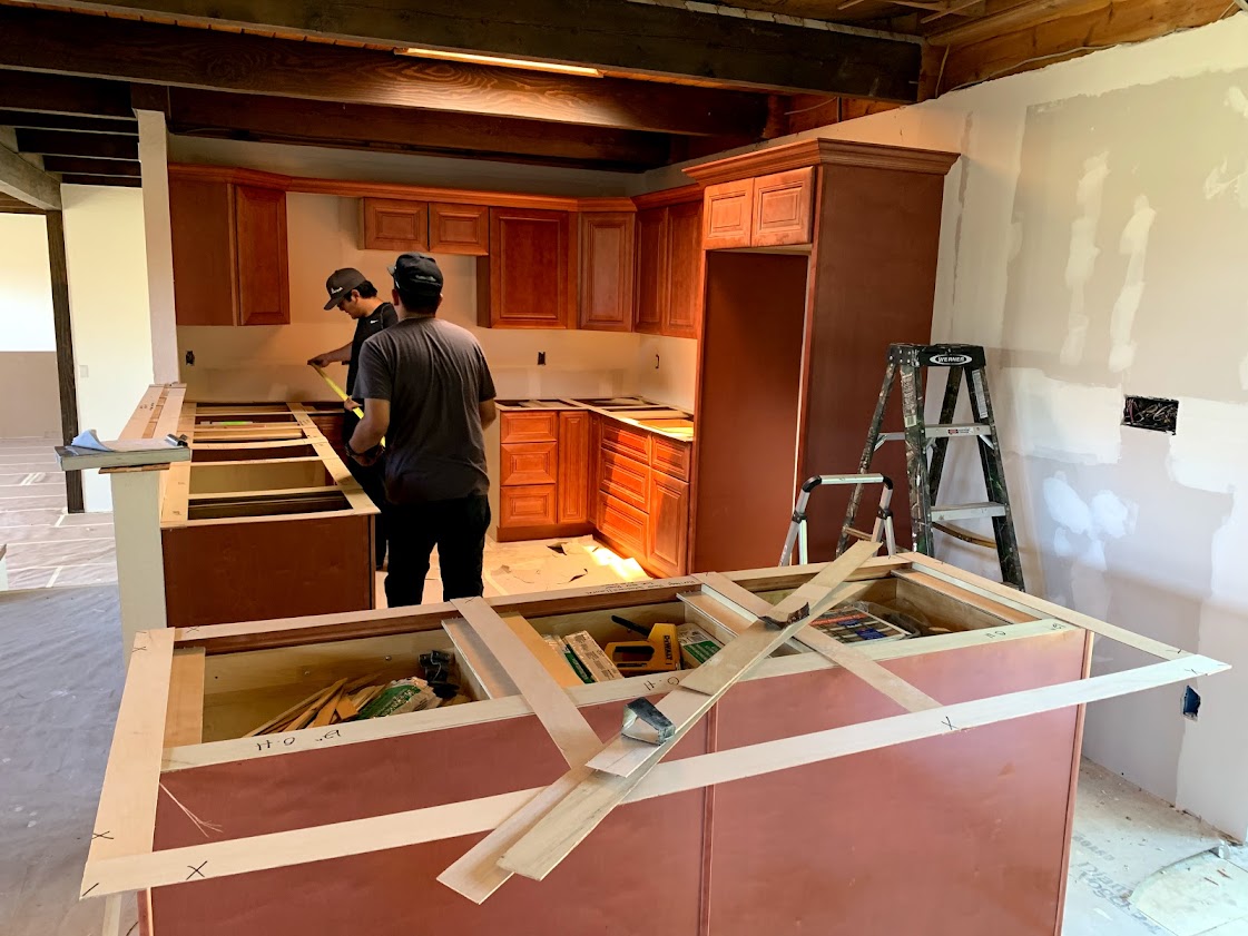 Semi-custom kitchen cabinets being installed during the kitchen remodel