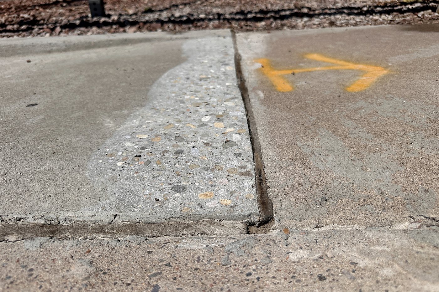 Finished sidewalk transition after grinding and cleanup in Albuquerque