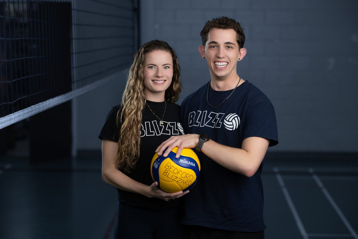 Two volleyball players in coordinated pose