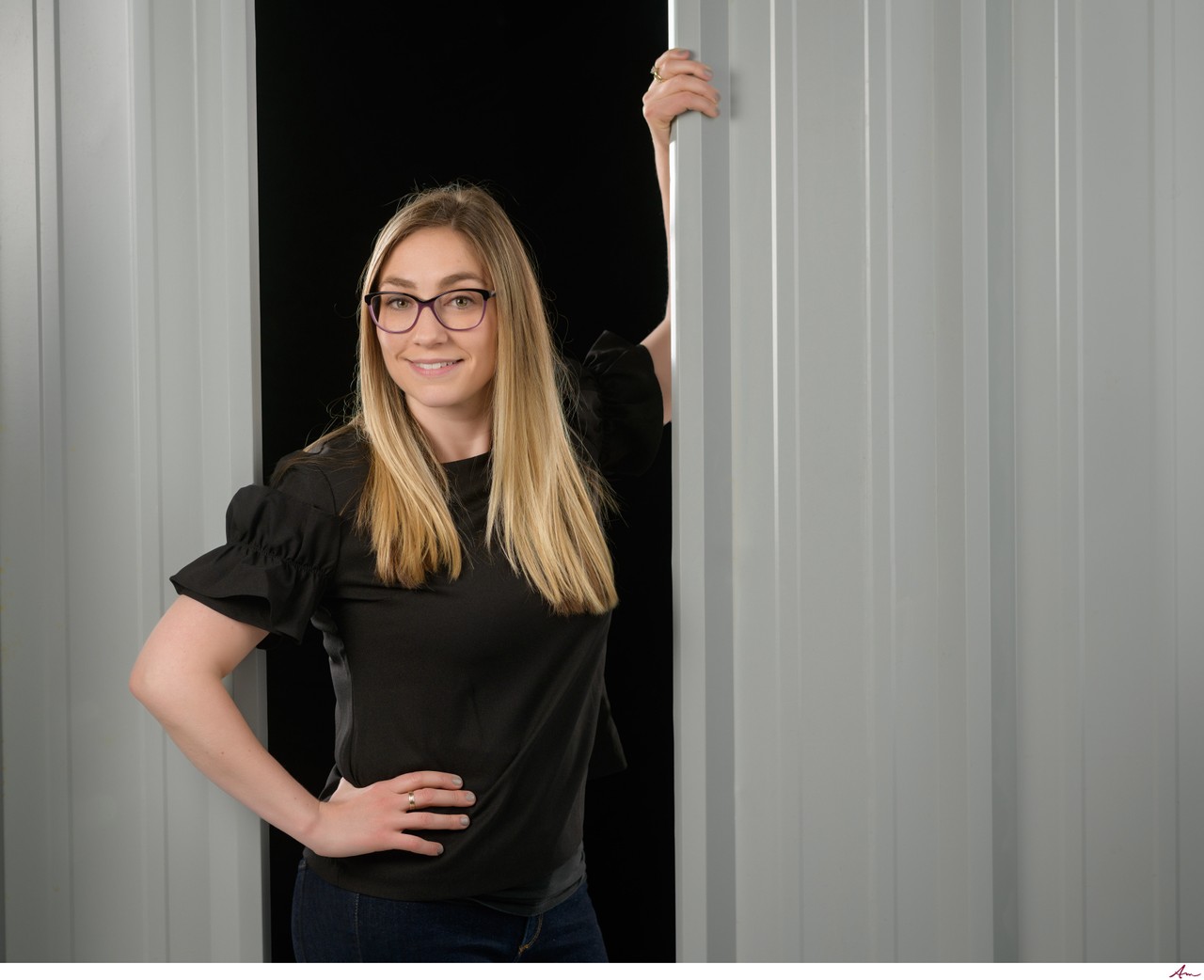 Scotia Metal Products team member between metal siding panels, Dartmouth corporate portrait