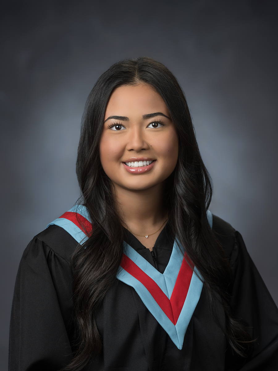 Bay View High grad in a black gown with a light blue and red sash, studio portrait in Halifax
