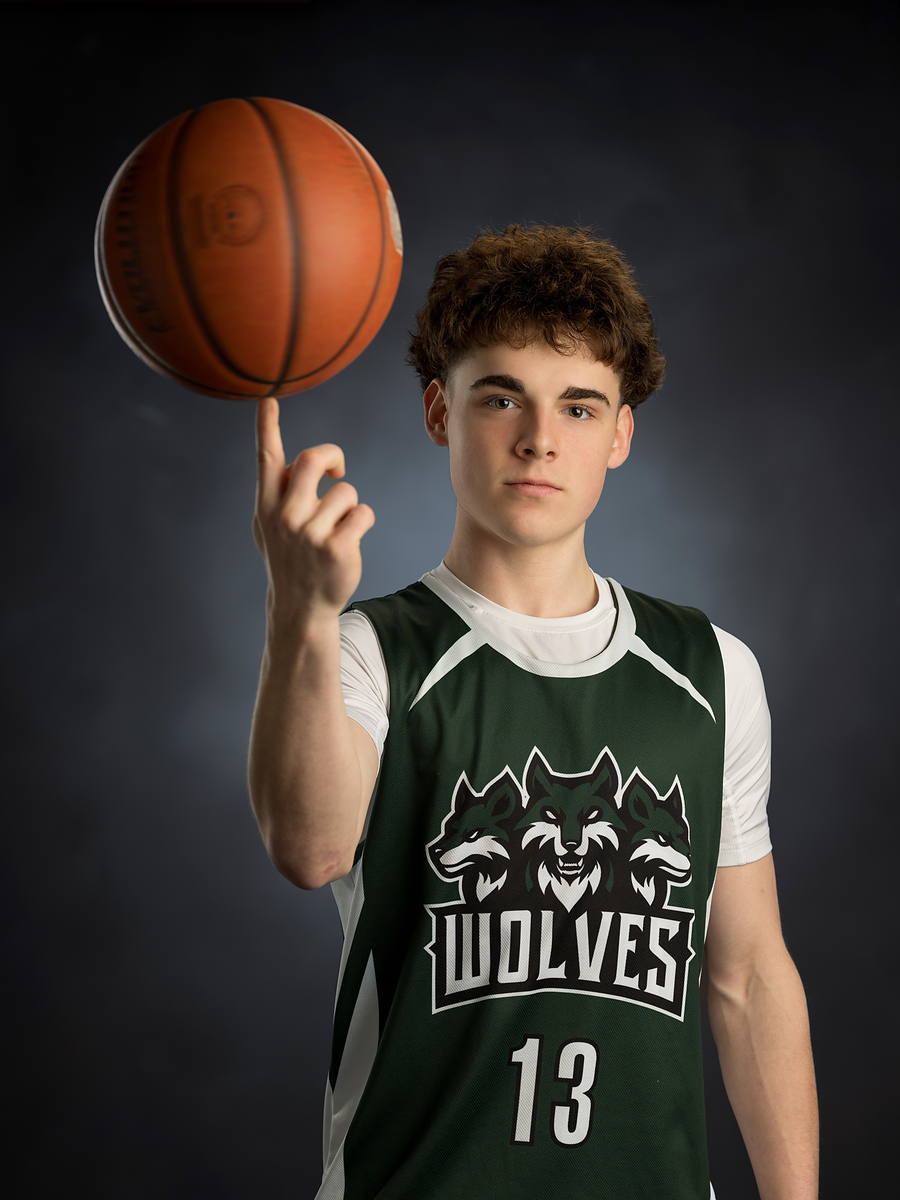 Grad in his Wolves basketball jersey spinning a ball on one finger, Halifax grad photo