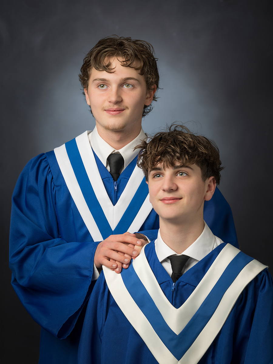 Two brothers graduating together in matching blue gowns with white sashes, Halifax grad photo