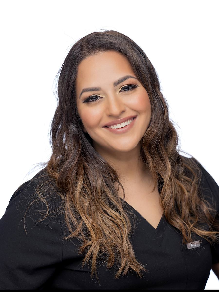 Headshot of Halifax dentist Dr. Reem Rostom in black scrubs, studio portrait on white