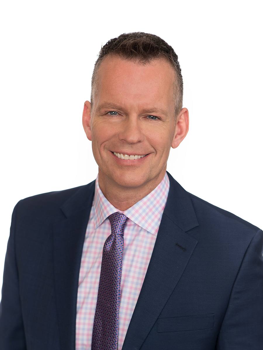 Headshot of CTV's Paul Hollingsworth in a navy suit and purple tie, Halifax studio portrait