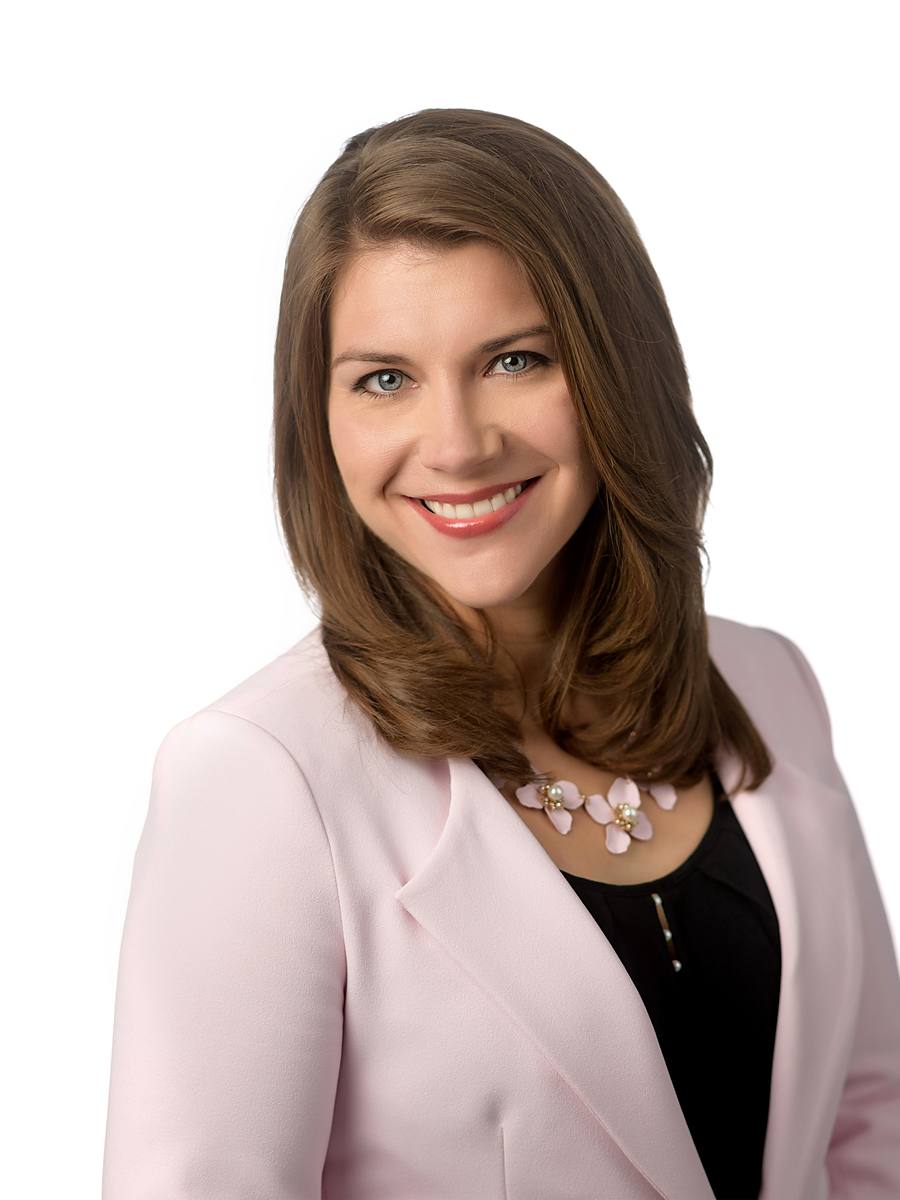 Headshot of Halifax author Kayla Hounsell in a pale pink blazer, studio portrait