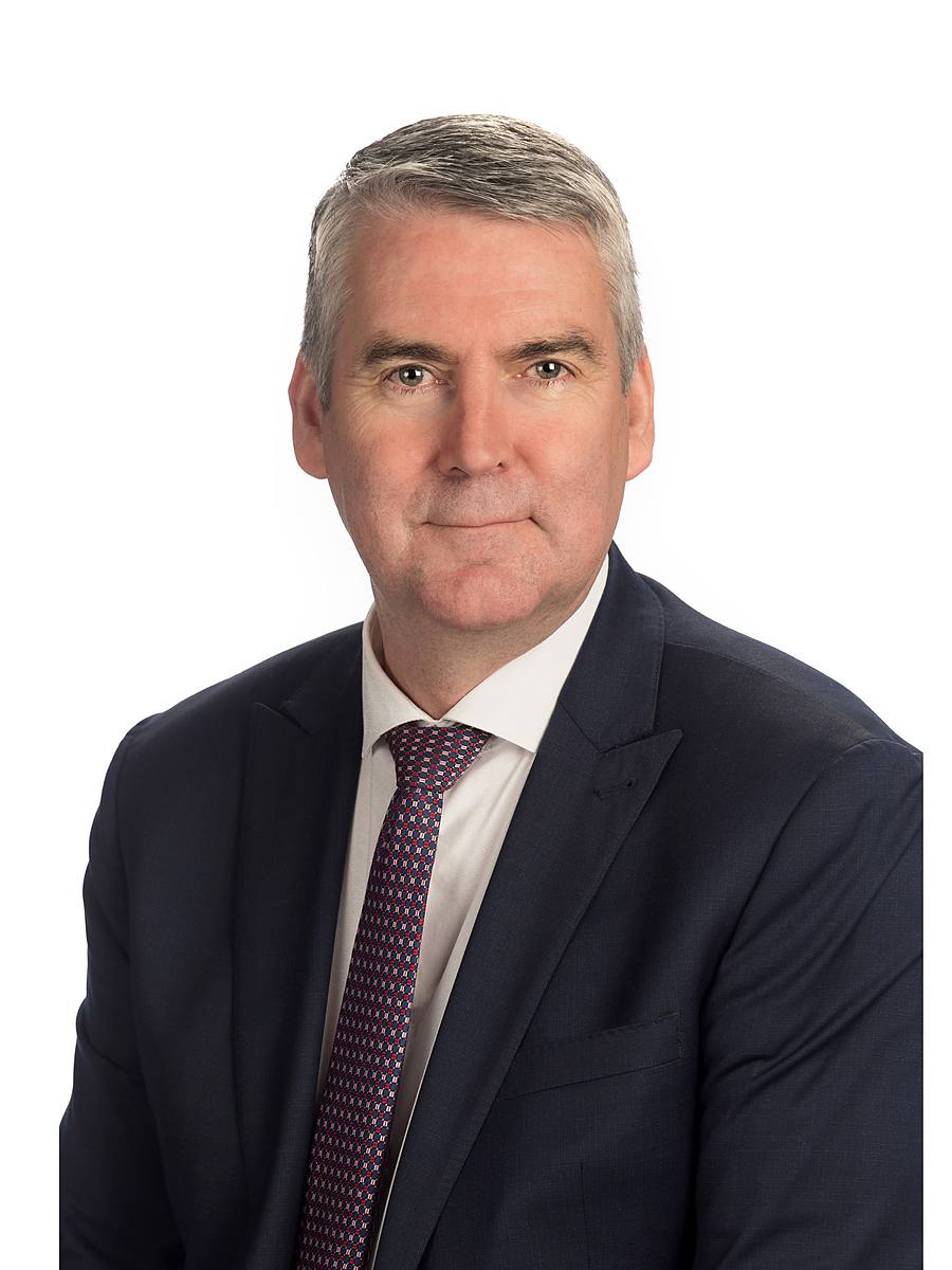 Headshot of former Nova Scotia Premier Stephen McNeil in a dark suit, Halifax studio portrait