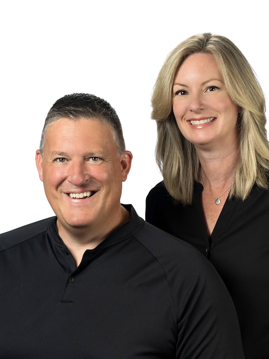Team headshot of Carrie and Michael Cook of Gotcha Covered Halifax in black, studio portrait on white