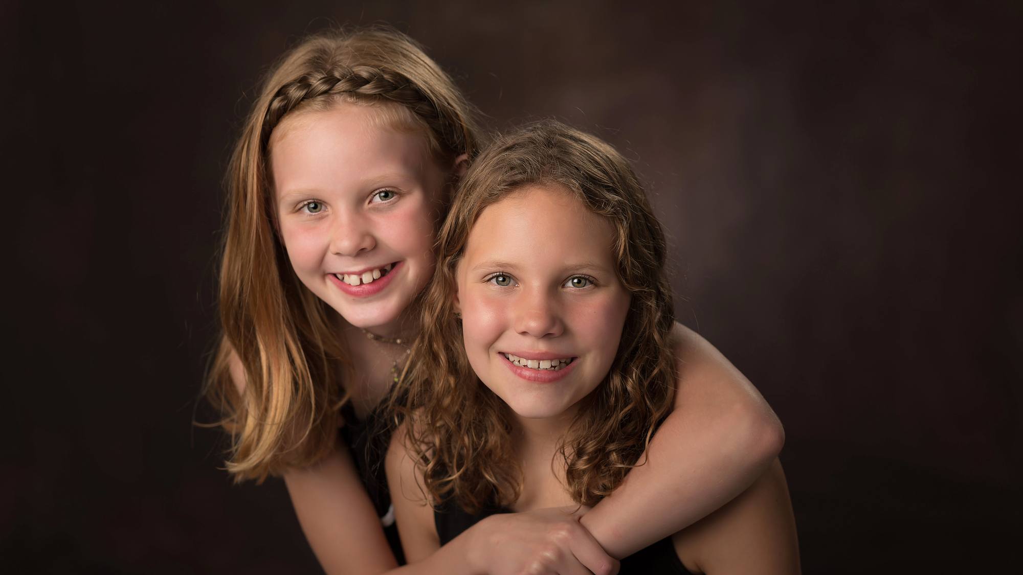 Two young sisters hugging - studio family portrait in Hammonds Plains