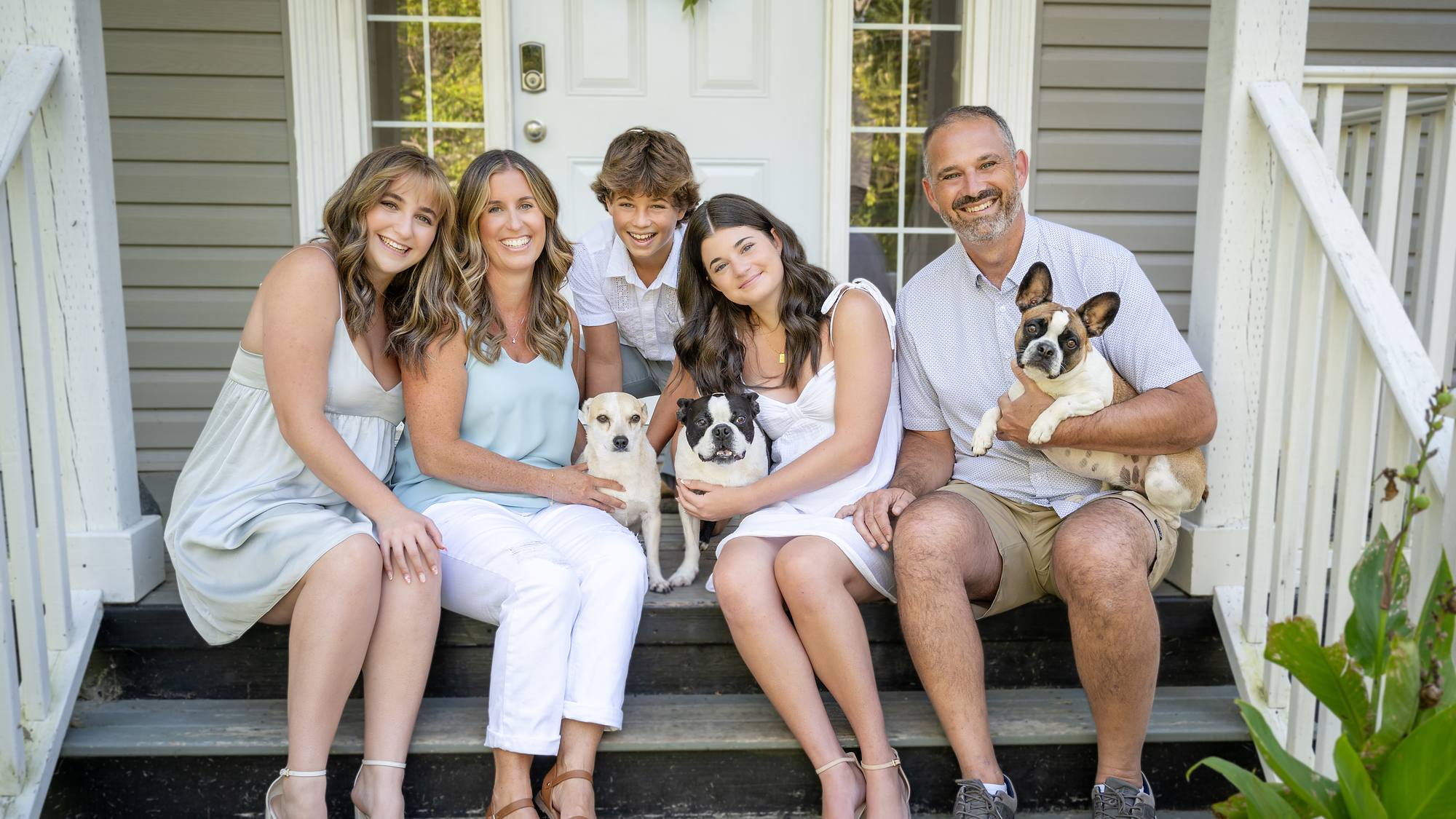 Family of five with their two dogs on the front steps - summer family session in Nova Scotia