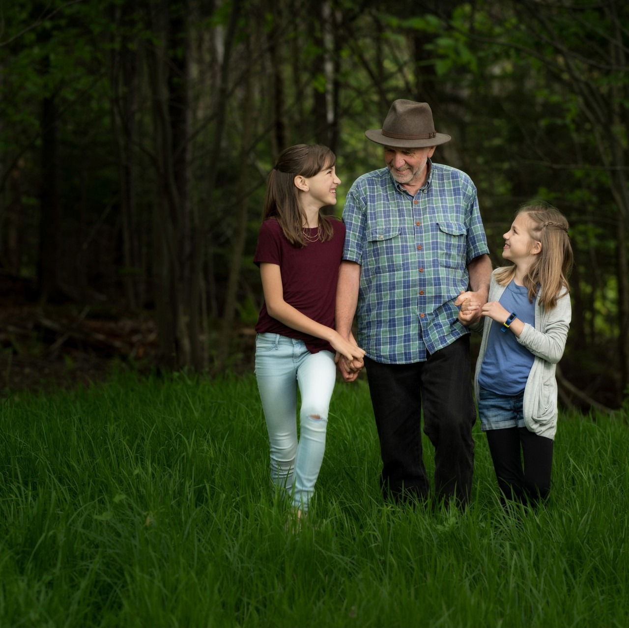 Grandfather walking hand in hand with his granddaughters, family session in Hammonds Plains