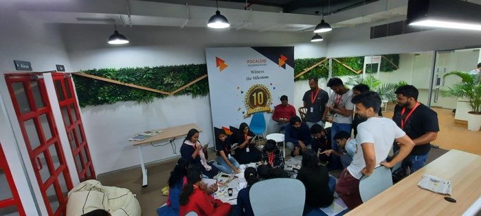 A wide view of the office floor during the Women’s Day painting session