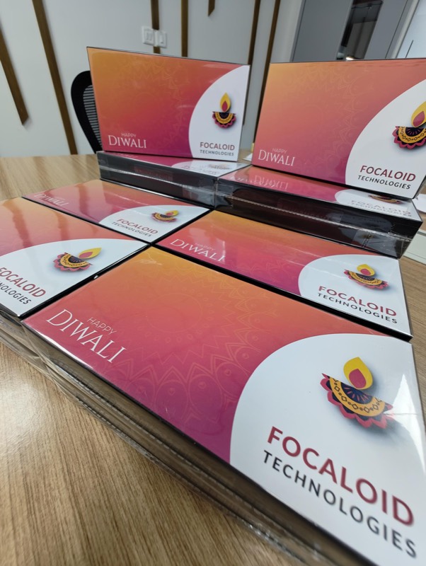 A stack of Focaloid-branded Happy Diwali gift boxes on a desk