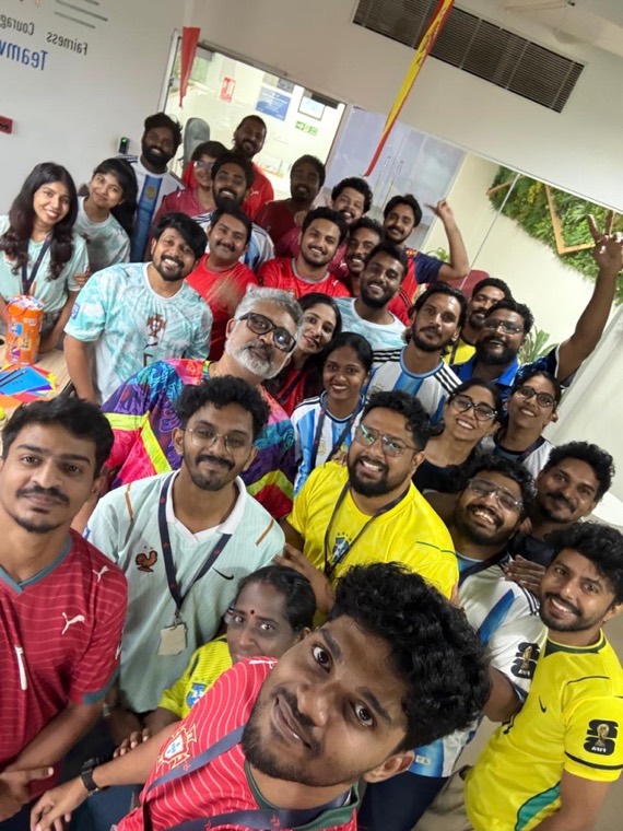 A crowd of colleagues in football jerseys crammed into a single selfie