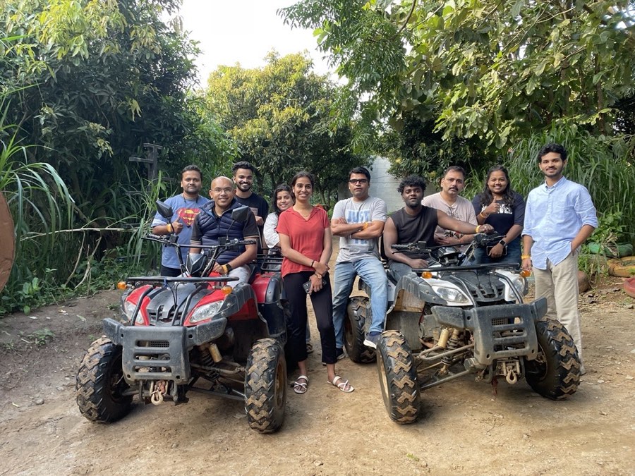 Colleagues sitting on two quad bikes on a forest track