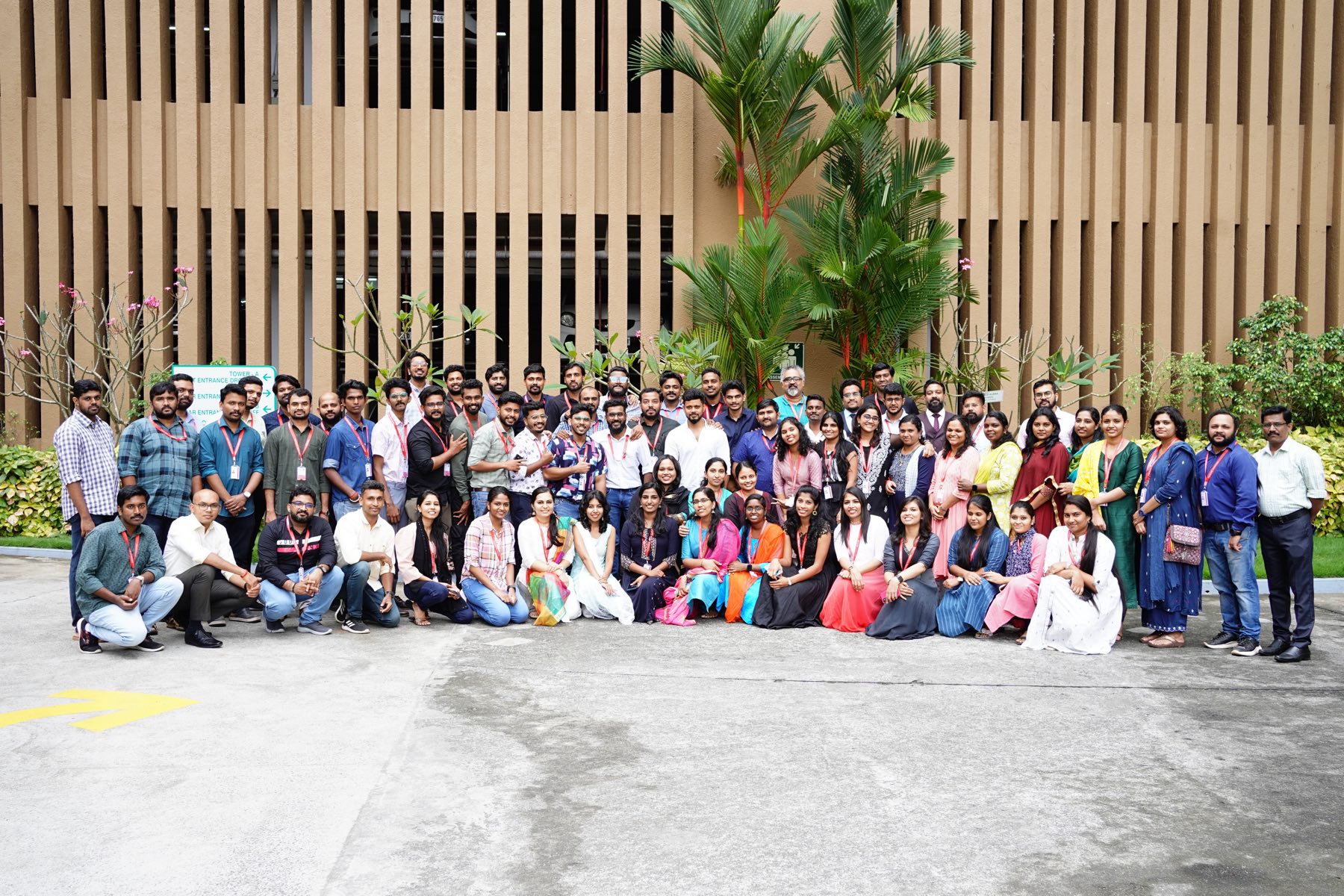The Focaloid team posed outdoors in front of Tower A at World Trade Center Kochi on the day the new floor opened