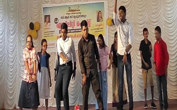 A group of students performing on stage in front of the Ability Fest banner