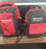 Two red and black backpacks printed with the Focaloid Technologies wordmark