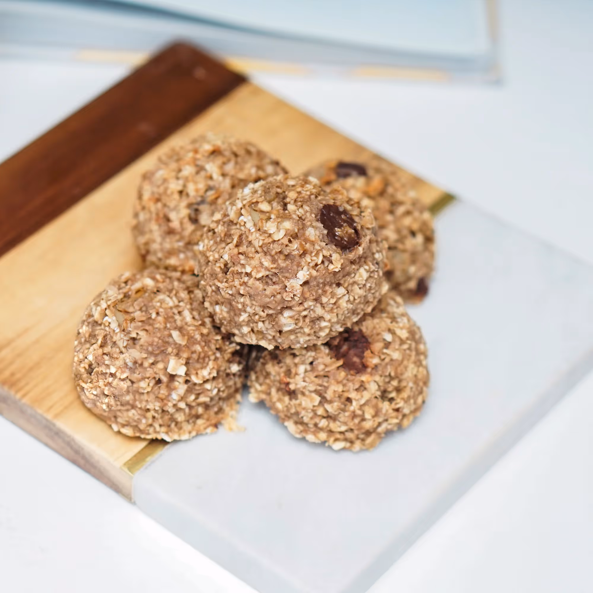 A wooden tray with four cereal balls on it.