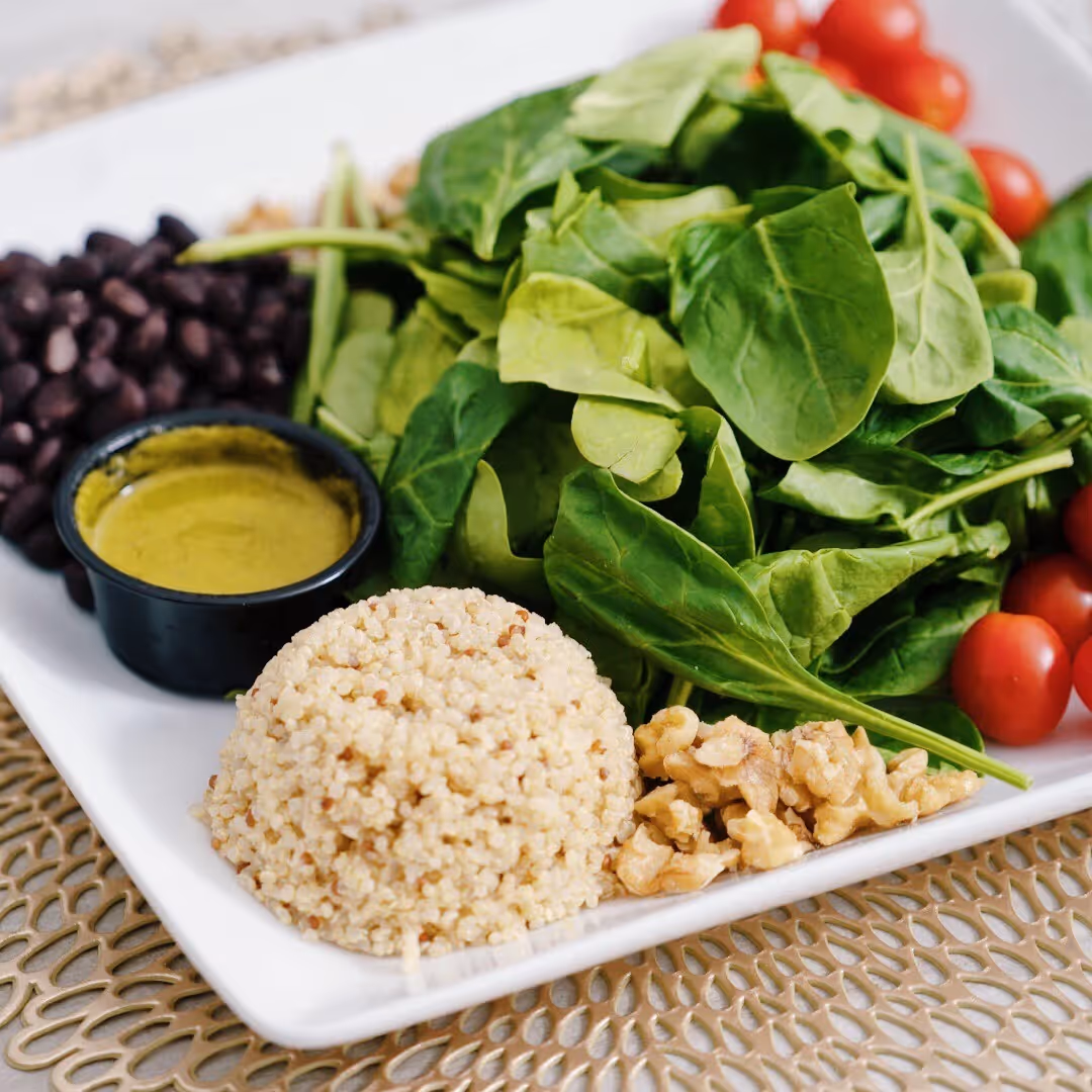 A white plate with a salad on it.