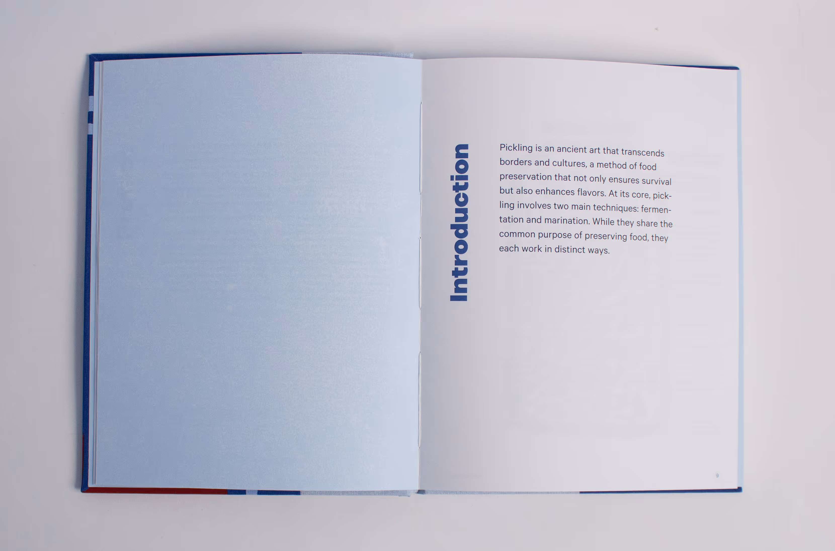 Open book displaying introduction text about pickling as an ancient food preservation method.