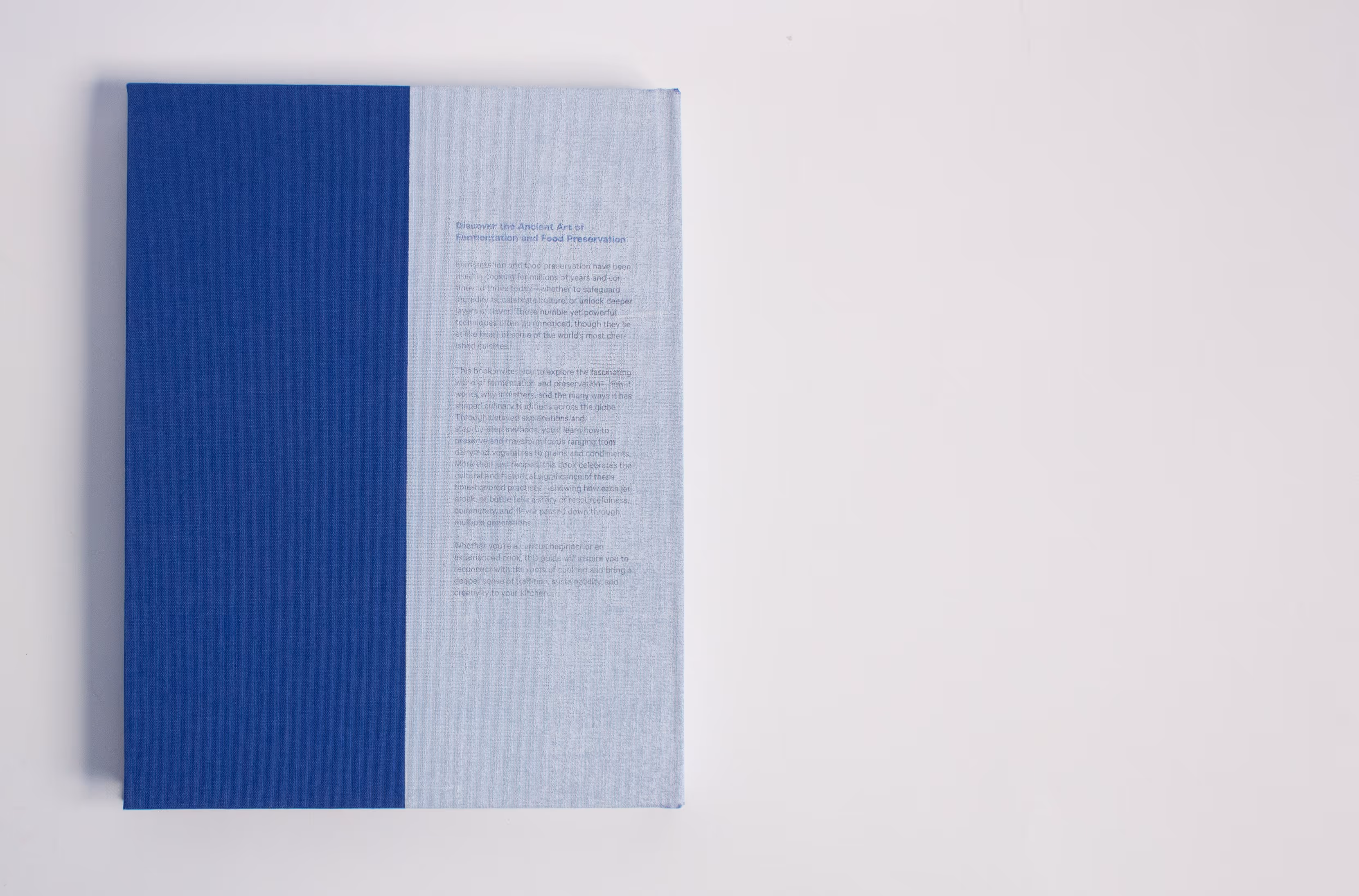 Closed book with two-tone cover in dark blue and light blue with text on the lighter side.