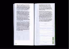 Open book with two pages of printed text on a black background.