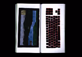 Open book with abstract black and blue vertical pattern on left and red outlined squares on right page.